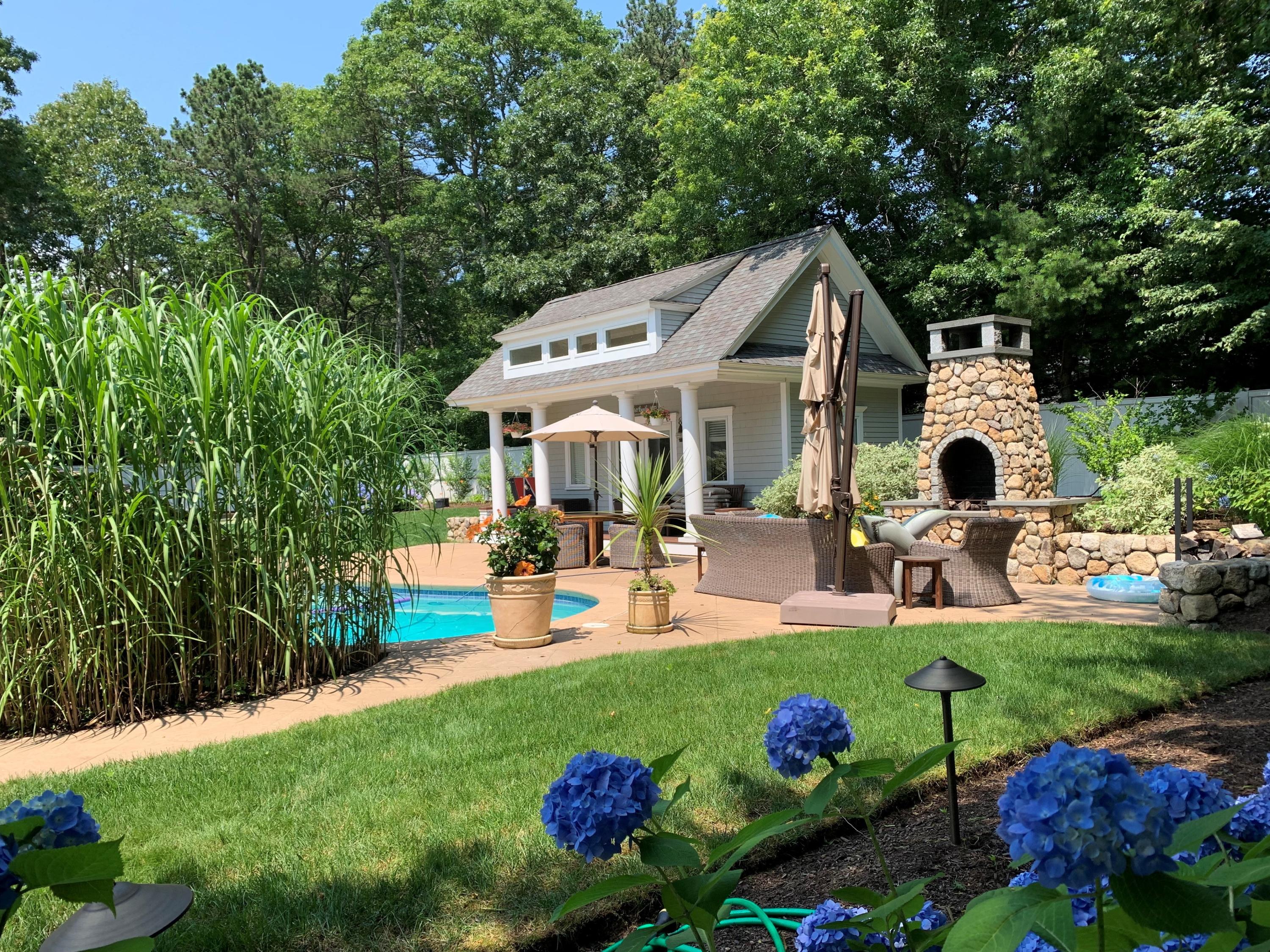 1490 South County Road Osterville, MA 02655 - Photo 5 of 75 a front view of a house with patio and garden