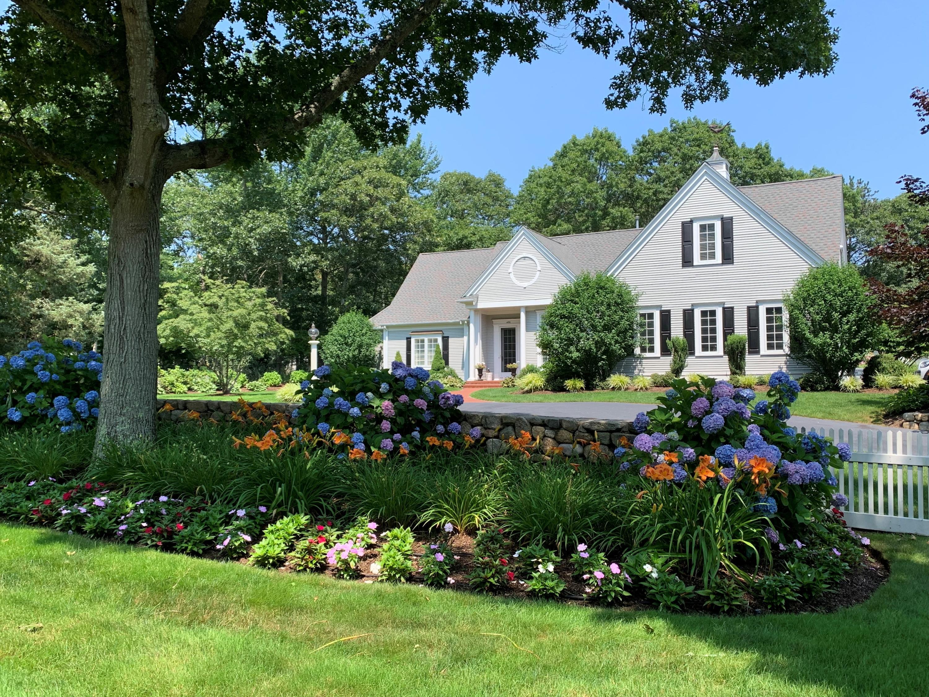 1490 South County Road Osterville, MA 02655 - Photo 75 of 75 a front view of a house with a yard and potted plants