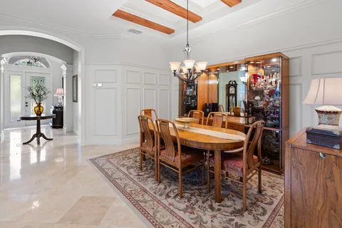 a spacious bedroom with a bed and a chandelier