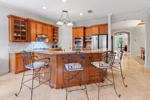 a bathroom with a granite countertop tub sink and mirror