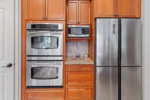 a bathroom with a granite countertop tub sink and mirror
