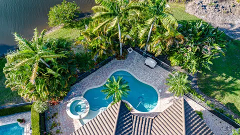 an aerial view of house with yard swimming pool and outdoor seating