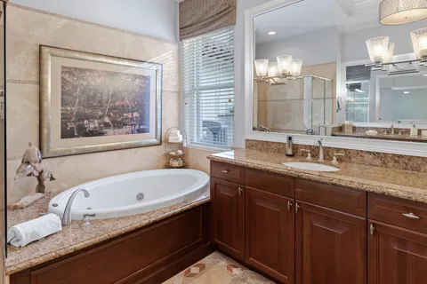 a room with lots of white furniture and windows