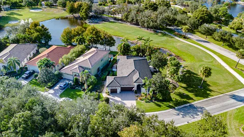 a living room with furniture a dining table and a chandelier