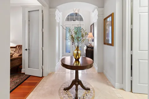 a kitchen with stainless steel appliances a stove a refrigerator and a dining table