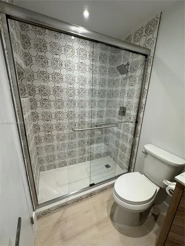 a bathroom with a toilet and shower
