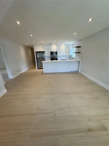a view of kitchen and empty room