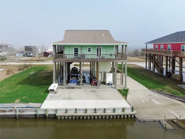 a view of a house with swimming pool next to a yard