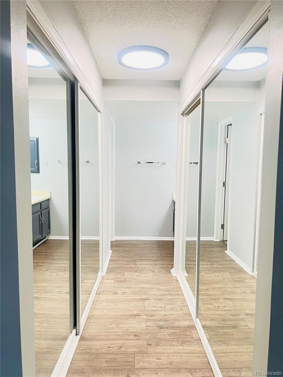 15911 East Dakota Place, Unit 301 Aurora, CO 80017 - Photo 12 of 18 a view of a hallway with wooden floor and a bathroom