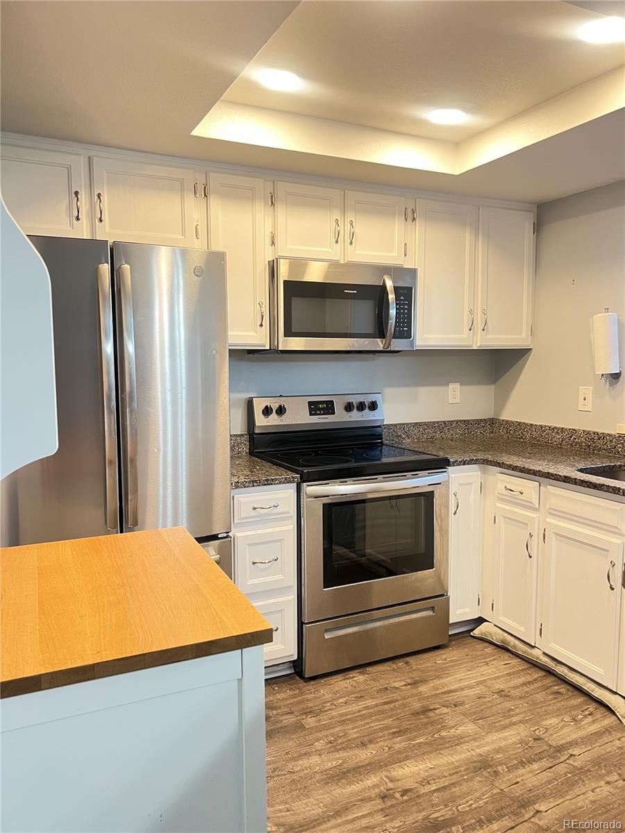 15911 East Dakota Place, Unit 301 Aurora, CO 80017 - Photo 3 of 18 a kitchen with stainless steel appliances a stove microwave and sink