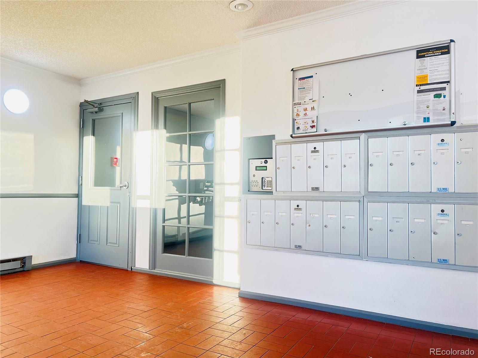 15911 East Dakota Place, Unit 301 Aurora, CO 80017 - Photo 7 of 18 an empty room with cabinet and wooden floor