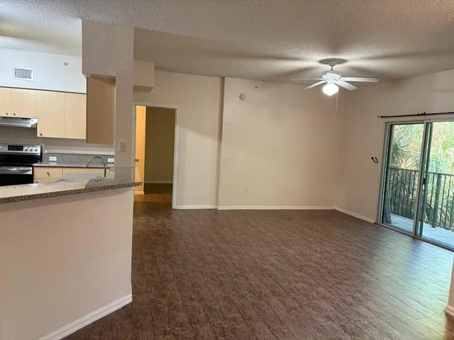 a view of a kitchen with a sink and a window