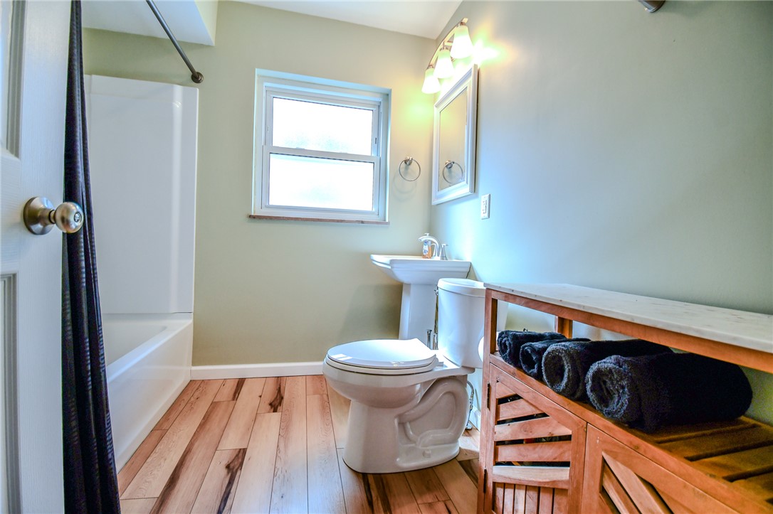 816 South Smithville Road Dayton, OH 45403 - Photo 18 of 33 This bright bathroom features warm wood-style flooring and a window for natural light.