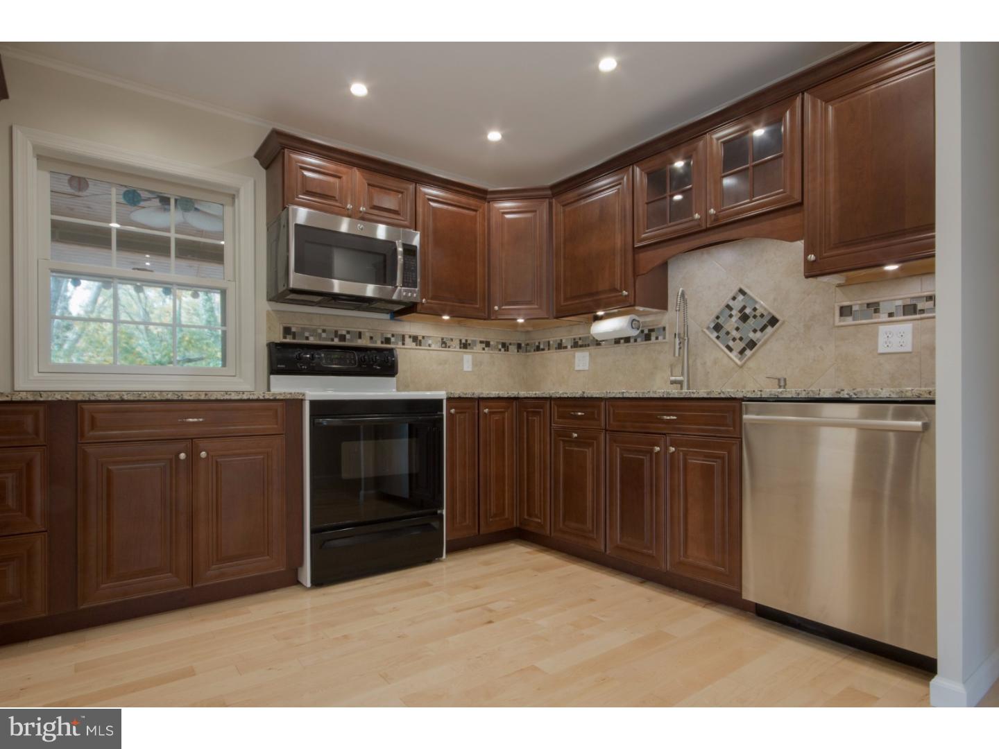 384 Walnut Lane Princeton, NJ 08540 - Photo 3 of 14 a kitchen with stainless steel appliances granite countertop a stove a sink and a refrigerator