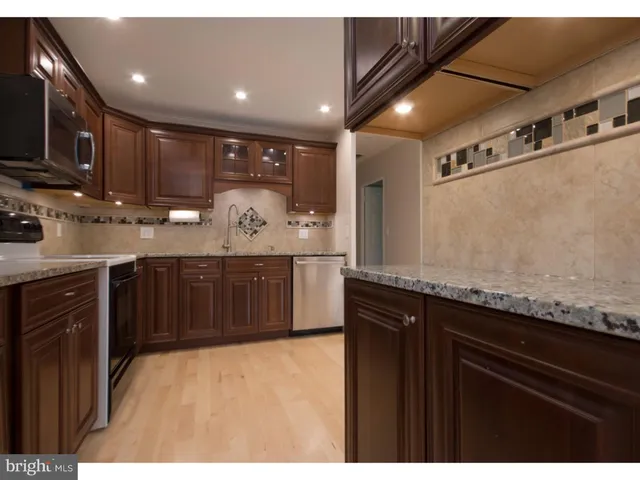 a kitchen with stainless steel appliances granite countertop a sink and cabinets