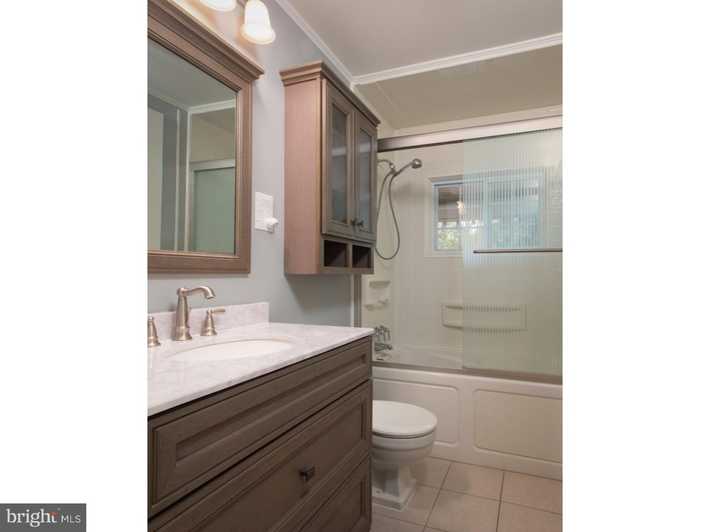384 Walnut Lane Princeton, NJ 08540 - Photo 10 of 14 a bathroom with a sink a toilet a shower and a mirror