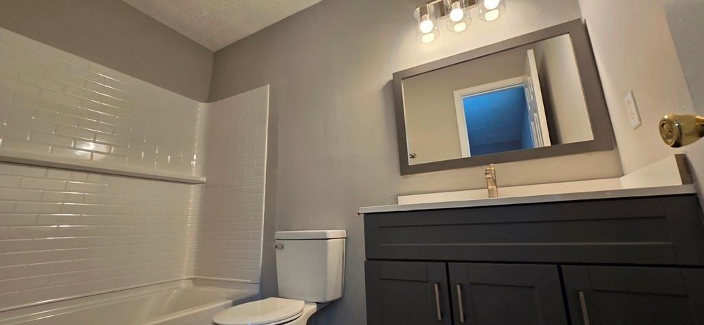 1020 Dassow Court Alpharetta, GA 30009 - Photo 14 of 18 a bathroom with a toilet sink and mirror