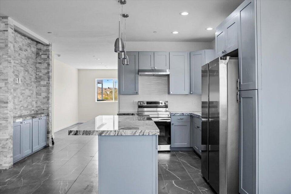 7608 Olympic Road Joshua Tree, CA 92252 - Photo 3 of 26 a kitchen with a refrigerator a sink and a stove