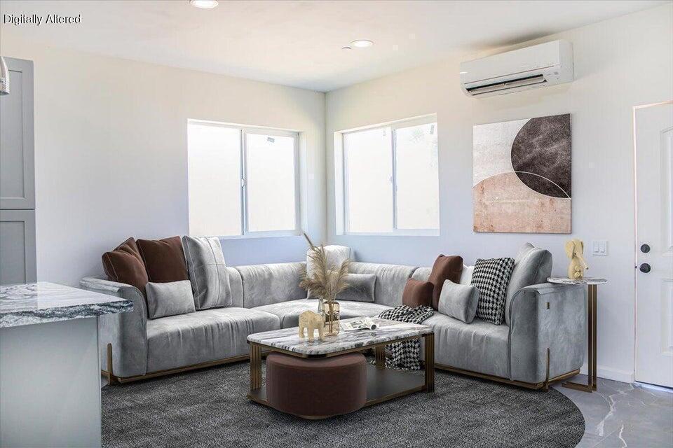 7608 Olympic Road Joshua Tree, CA 92252 - Photo 4 of 26 a living room with furniture and a large window