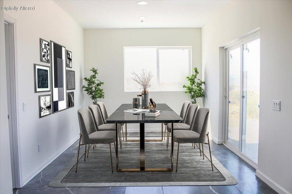 7608 Olympic Road Joshua Tree, CA 92252 - Photo 5 of 26 a dining room with furniture window and wooden floor