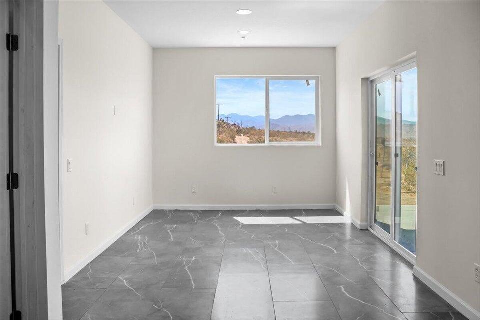 7608 Olympic Road Joshua Tree, CA 92252 - Photo 6 of 26 a view of an empty room with a window