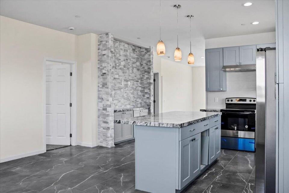 7608 Olympic Road Joshua Tree, CA 92252 - Photo 8 of 26 a kitchen with granite countertop a stove cabinets and refrigerator