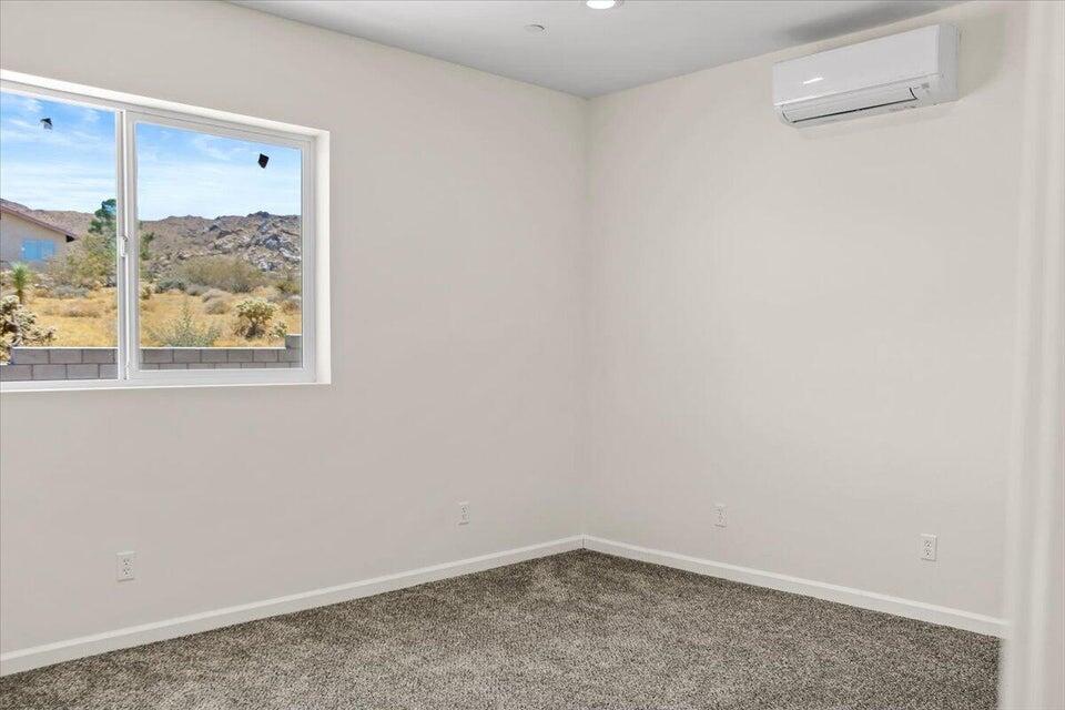 7608 Olympic Road Joshua Tree, CA 92252 - Photo 10 of 26 a view of a small space with wooden floor and a window