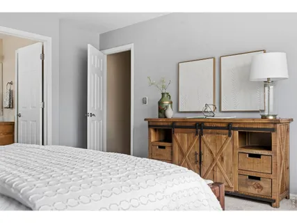 a bedroom with a bed and a mirror