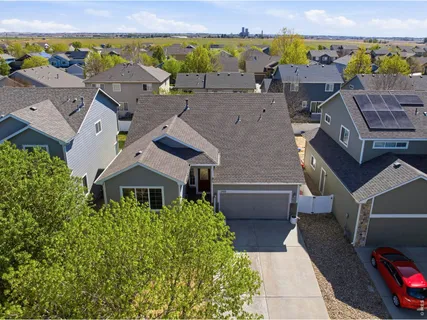 an aerial view of multiple houses with a yard