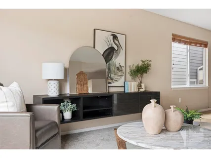 a living room with furniture and a mirror