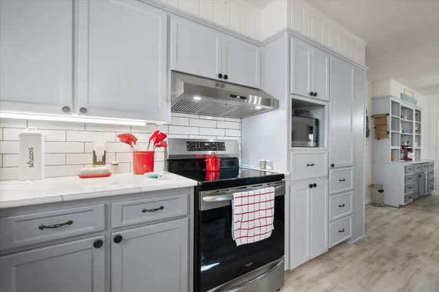 a utility room with cabinets washer and dryer