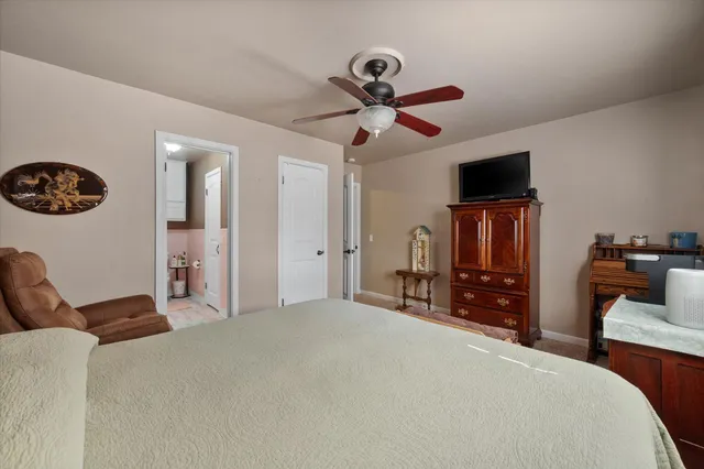 a bedroom with a bed and a television