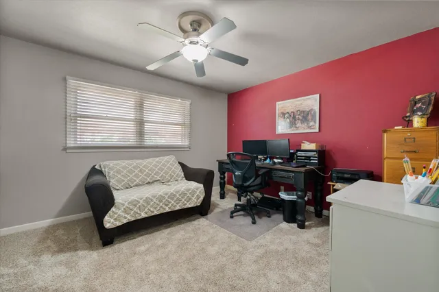 a living room with furniture and a work place area