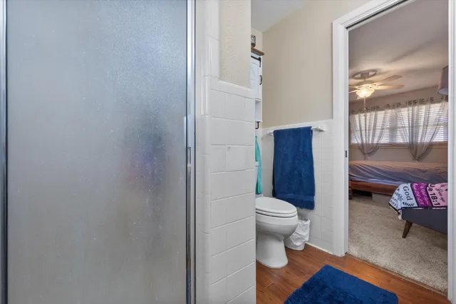 a bathroom with a toilet and a shower curtain
