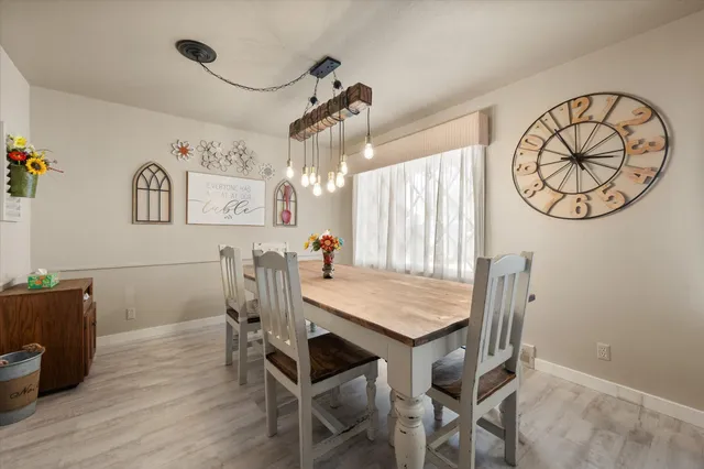 a view of a dining room with furniture and window