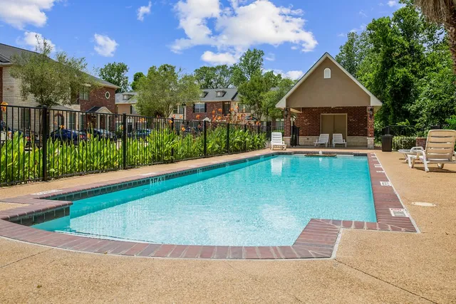a view of a house with pool fire pit a patio and a garden
