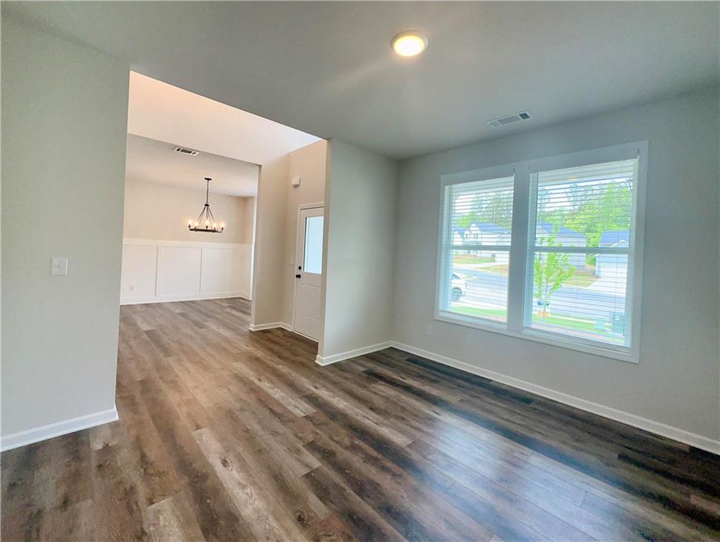 2226 Sun Valley Buford, GA 30519 - Photo 5 of 22 wooden floor in an empty room with a window