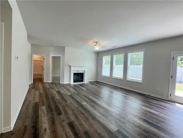 a view of empty room with wooden floor and fireplace