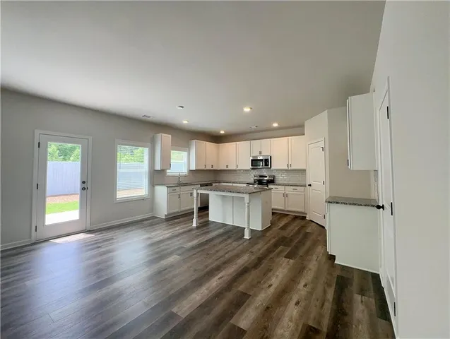a kitchen with a refrigerator and a stove top oven