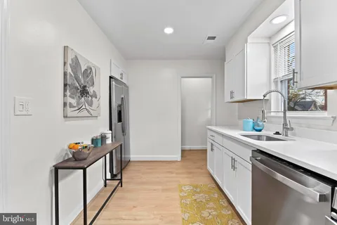 a kitchen with a sink and a refrigerator