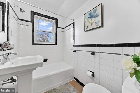 a bathroom with a toilet a sink and bathtub