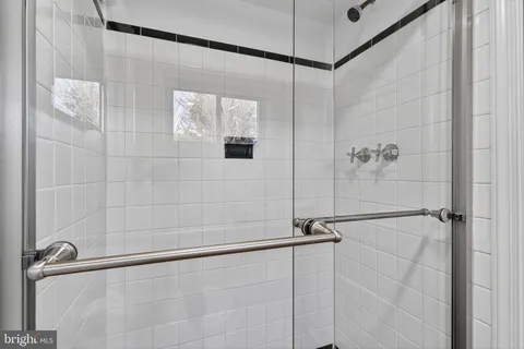 a bathroom with a shower and a shower