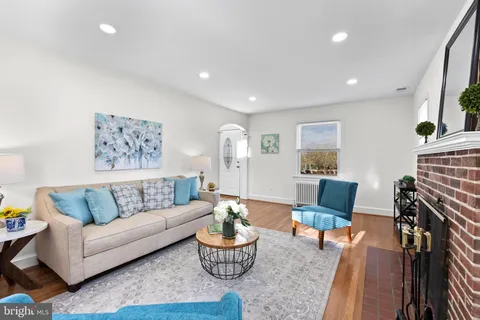 a living room with furniture or couch and a wooden floor