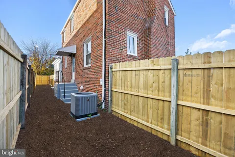 a view of a patio with furniture and wooden fence