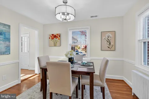 a view of a dining room with furniture wooden floor and a chandelier