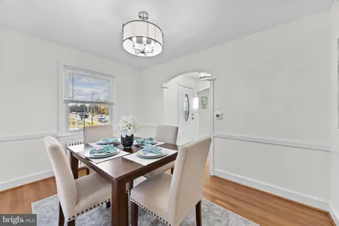 a view of a dining room with furniture and chandelier