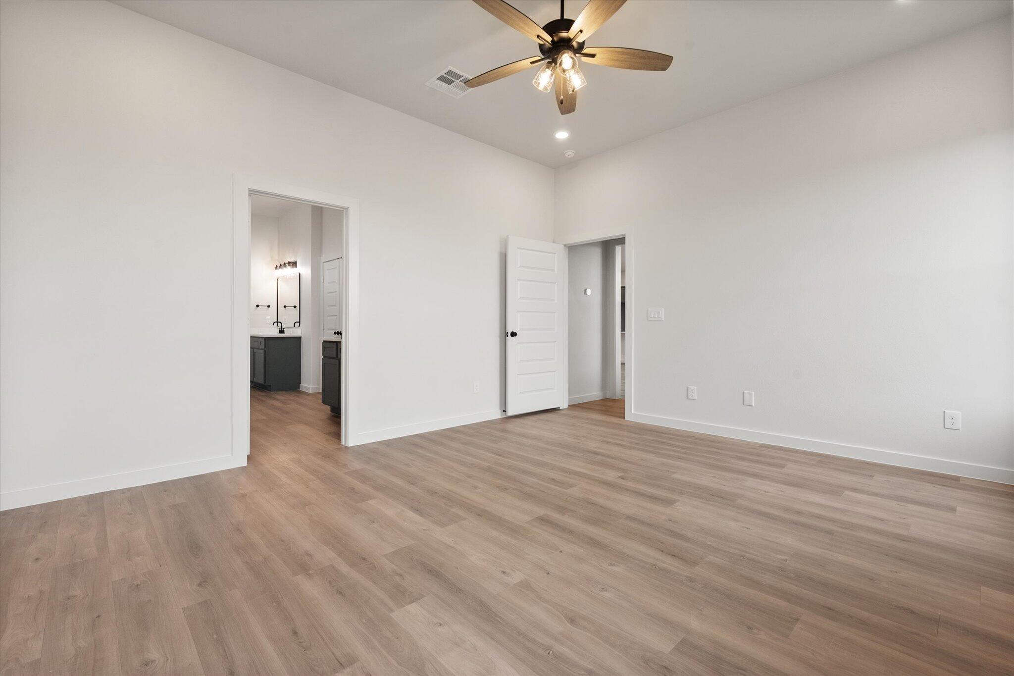 2901 Tractor Avenue Wolfforth, TX 79382 - Photo 13 of 25 a view of an empty room with wooden floor