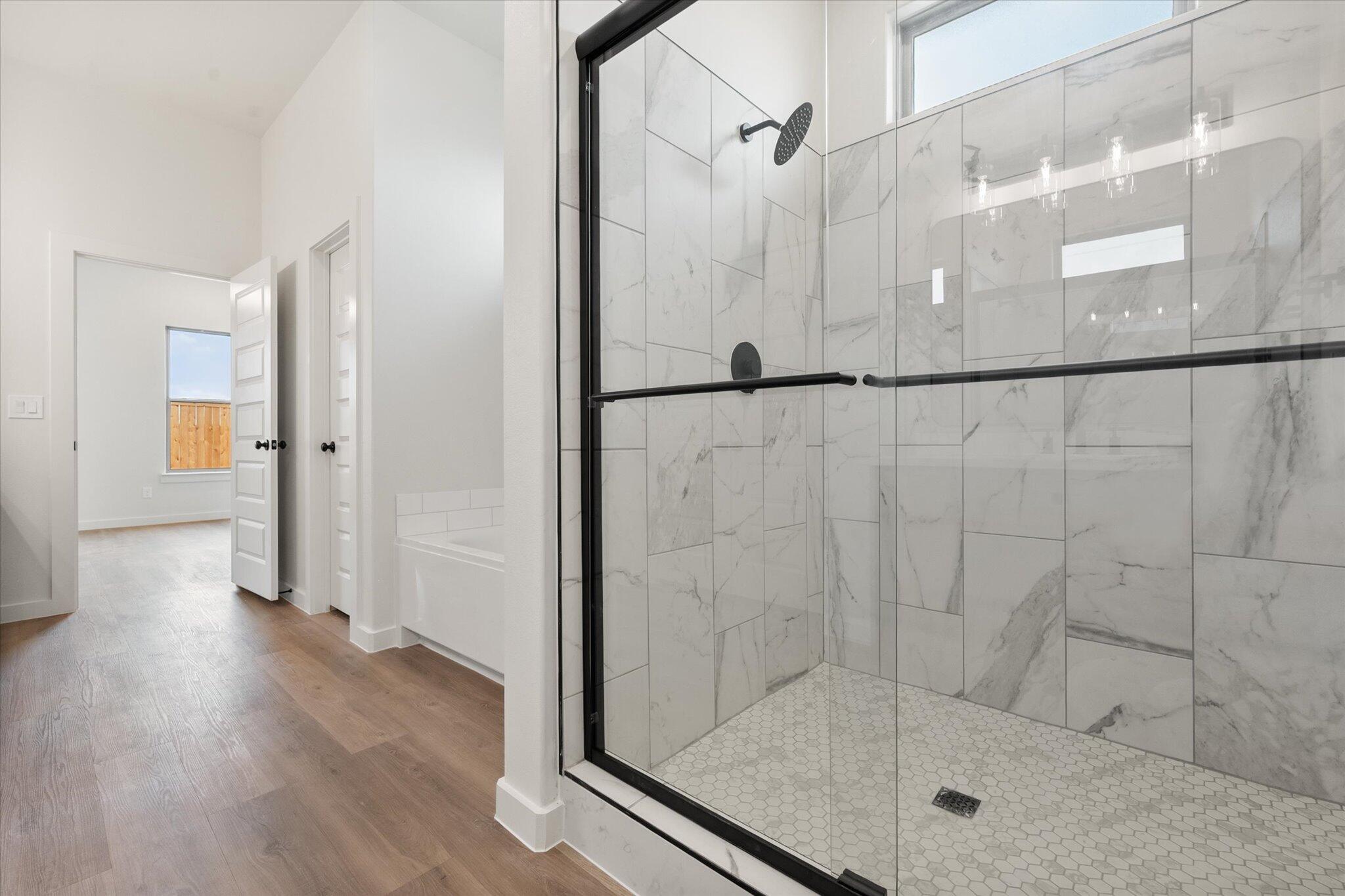 2901 Tractor Avenue Wolfforth, TX 79382 - Photo 17 of 25 a bathroom with a glass shower door