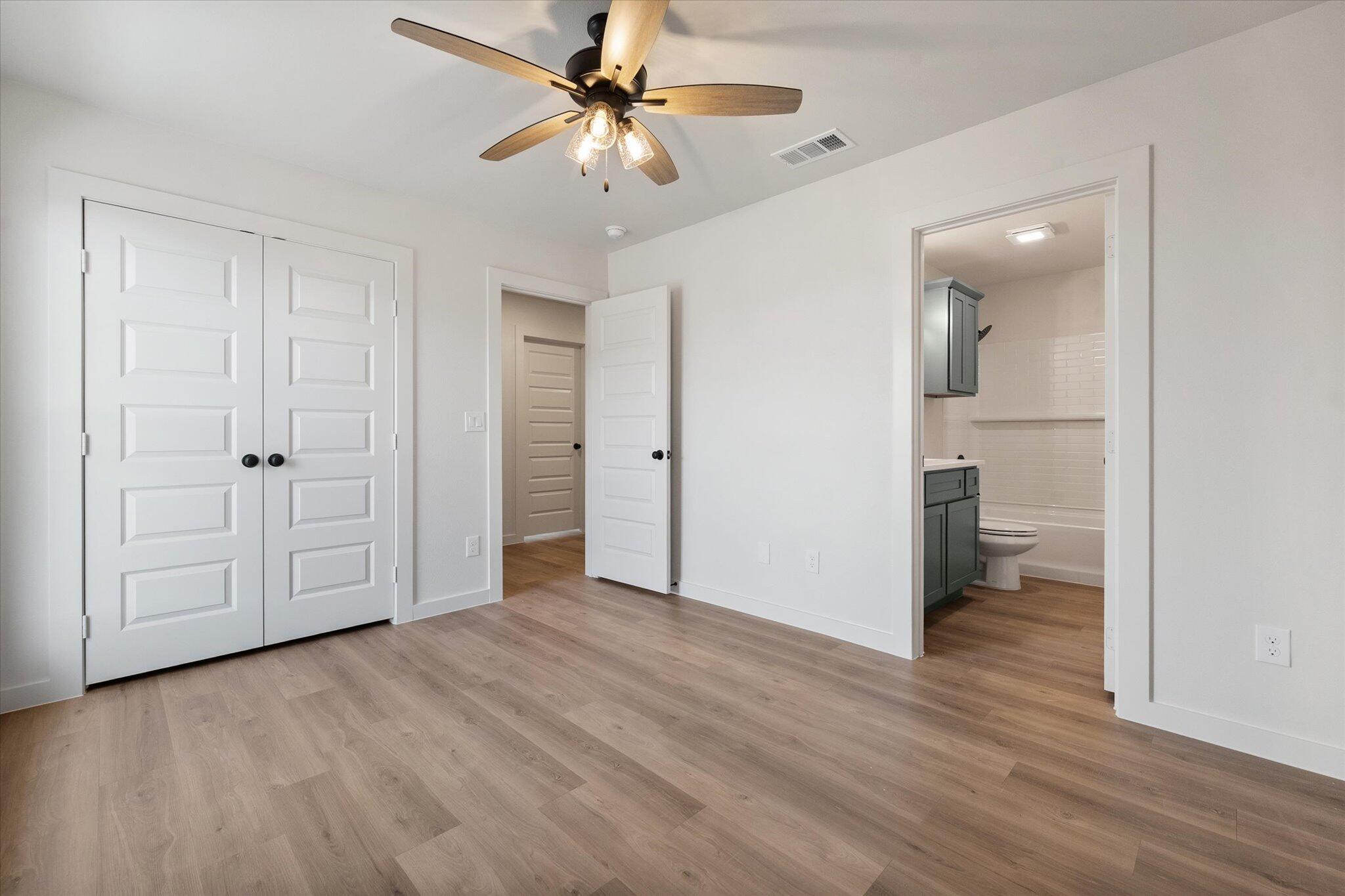 2901 Tractor Avenue Wolfforth, TX 79382 - Photo 18 of 25 a view of empty room with wooden floor and ceiling fan