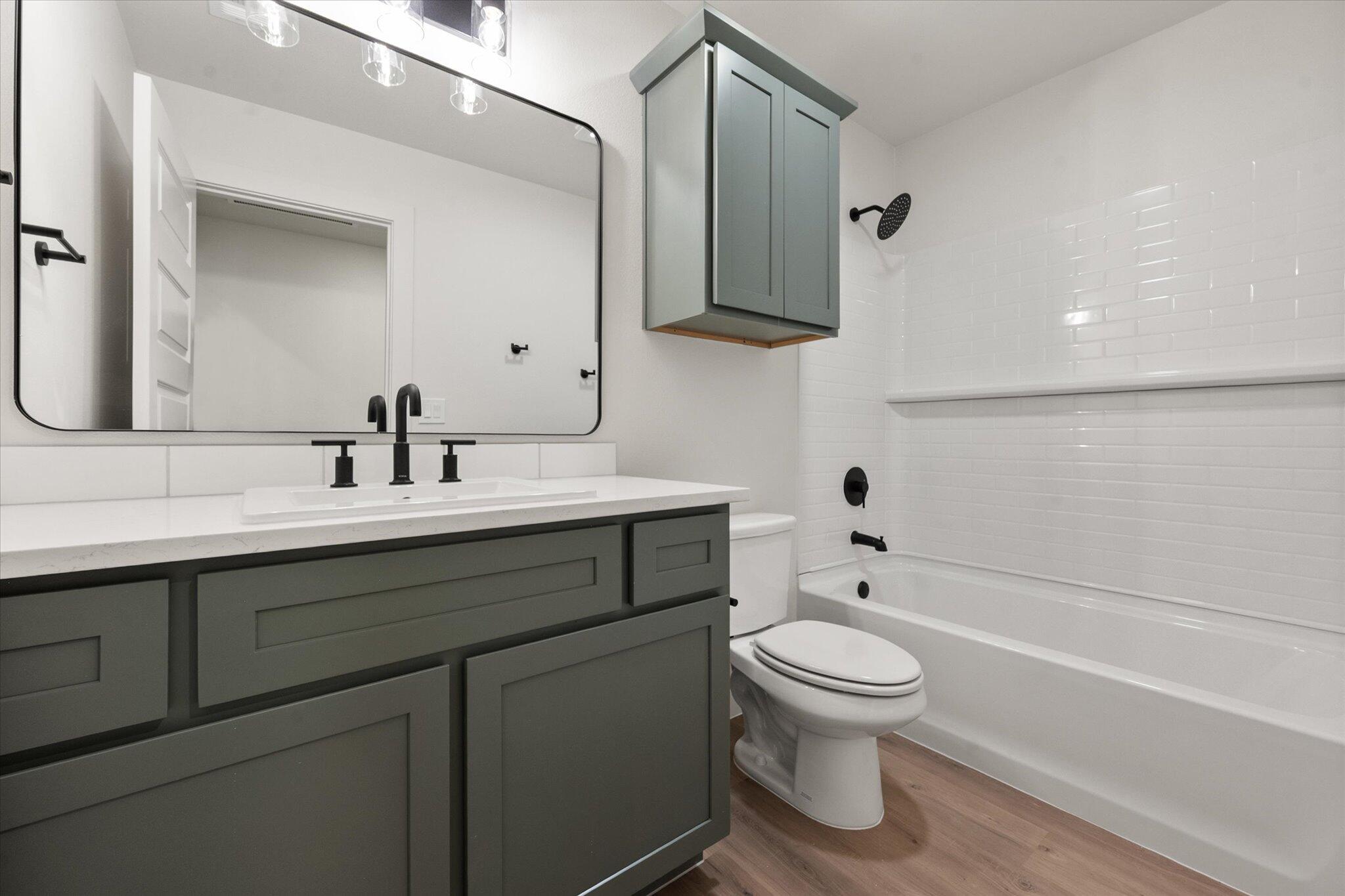 2901 Tractor Avenue Wolfforth, TX 79382 - Photo 19 of 25 a bathroom with a toilet sink and mirror